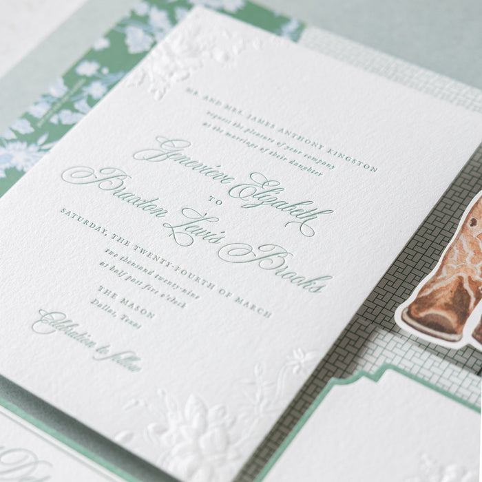 Detailed view of a wedding invitation with text and design elements.