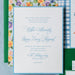 Hadaway v2 wedding invitation set with floral and checkered designs on a blue background
