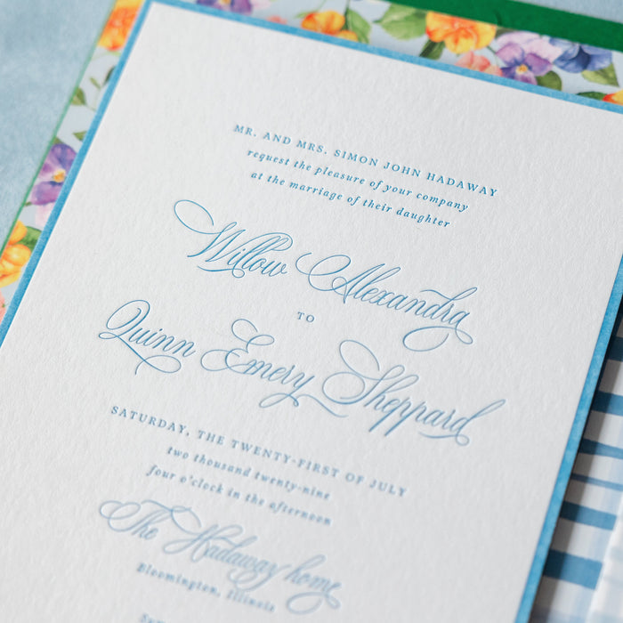 Hadaway v2 wedding invitation with floral design on a checkered fabric background