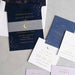 Selene Wedding invitation set with navy and gold design on a gray surface