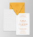 Wedding invitation set with orange envelope and white card on a gray background