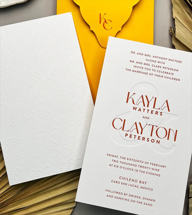 Wedding invitation card on a textured surface.