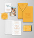 Calor wedding invitation suite with orange and white design on a gray background