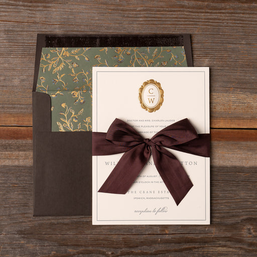 Charmain Invitation card with brown bow on a wooden surface