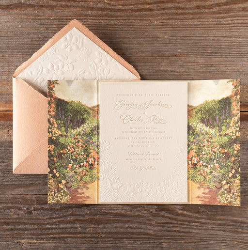 DelevingnenInvitation card with floral design on a wooden surface