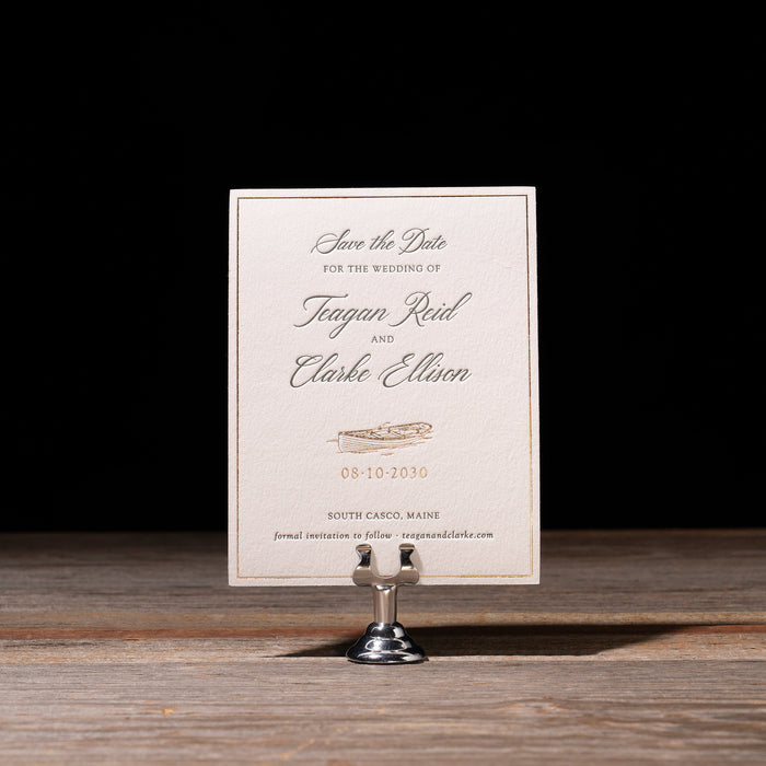 Ellison Wedding save the date card on a stand with a dark background