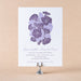 Gloria Wedding invitation with purple floral design on a beige background