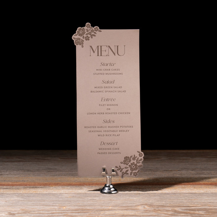 Menu card on a stand with decorative elements against a dark background