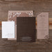 Wedding invitation set with floral design on a wooden background