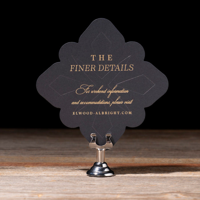 Decorative card with text on a stand against a dark background