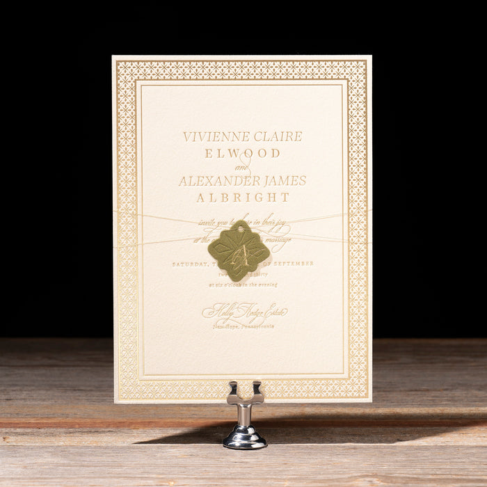 Decorative frame with a certificate on a wooden surface against a black background