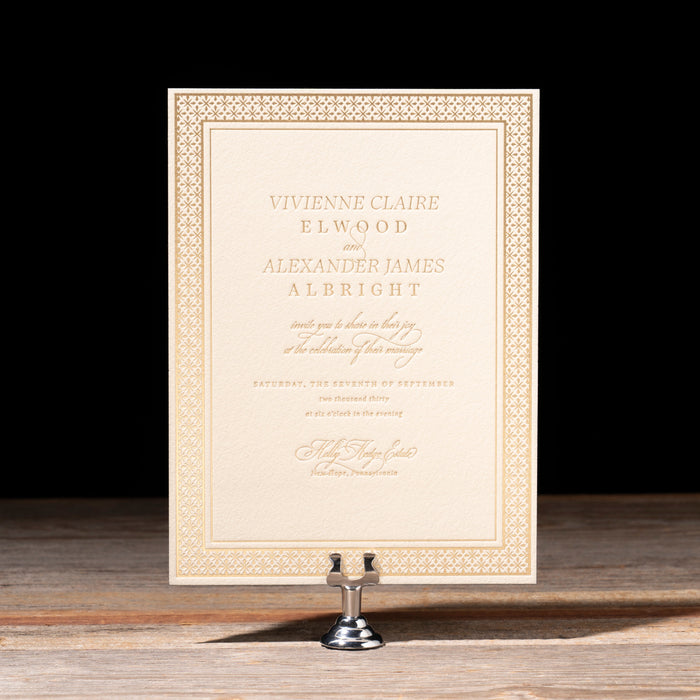Decorative wedding invitation on a stand with a black background