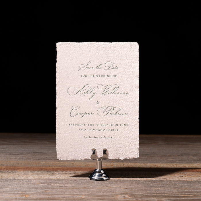 Ashby Save the Date card on a stand with a dark background