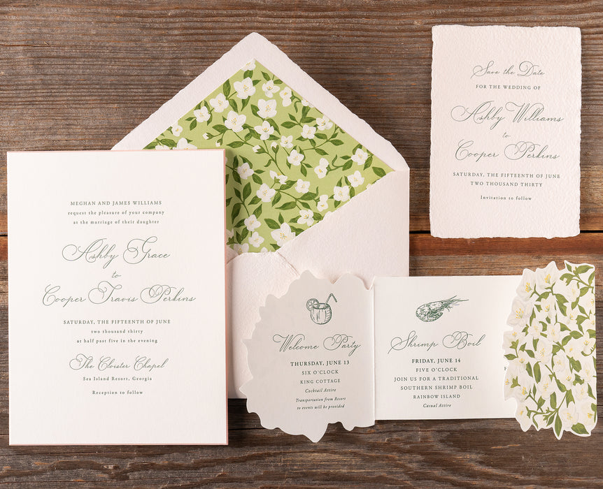 Ashby Wedding invitation set with floral design on a wooden surface