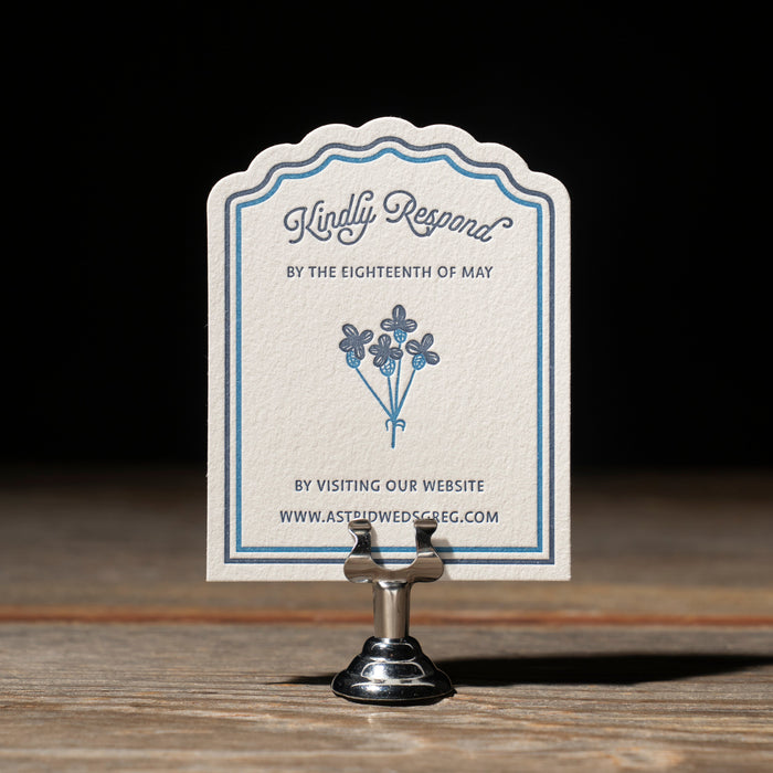 Astrid reply card on stand against a dark background