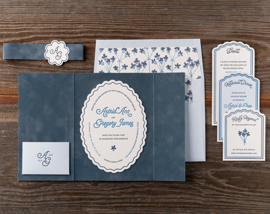 Astrid Wedding invitation set with RSVP card and details on a wooden surface