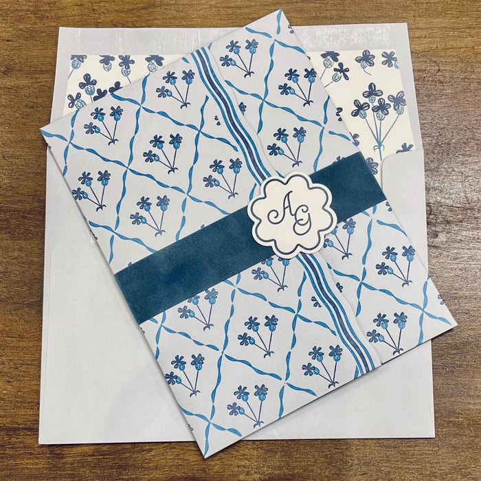 Astrid wedding invitation (closed) on a wooden surface