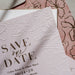 Floral embossed 'Save the Date' card with pink floral design