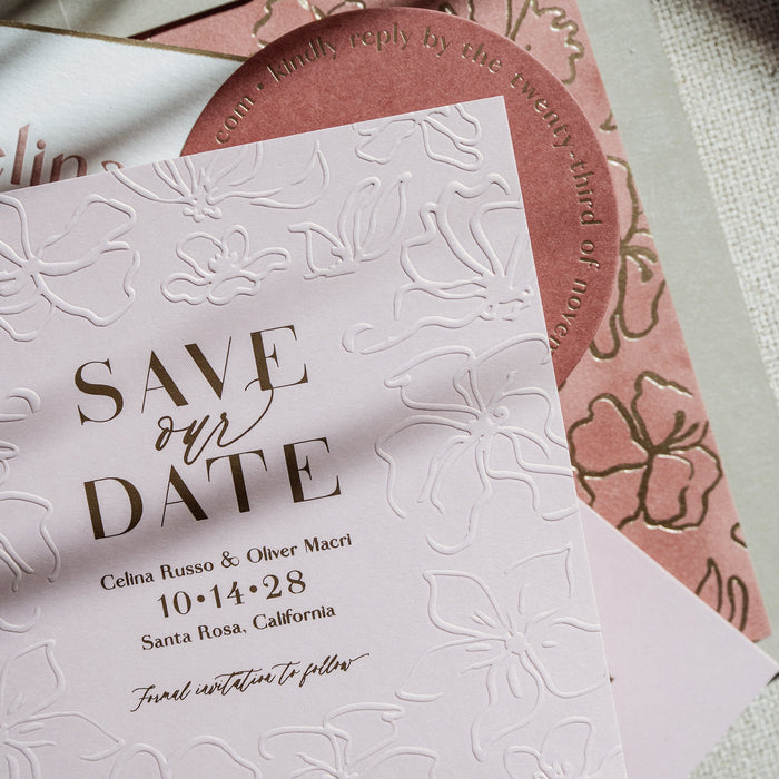 Invitation card with 'Save the Date' text on a textured surface
