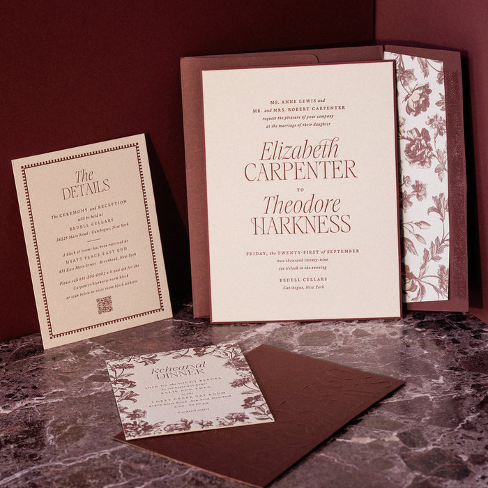 Harkness wedding invitation set with floral design on a marble surface