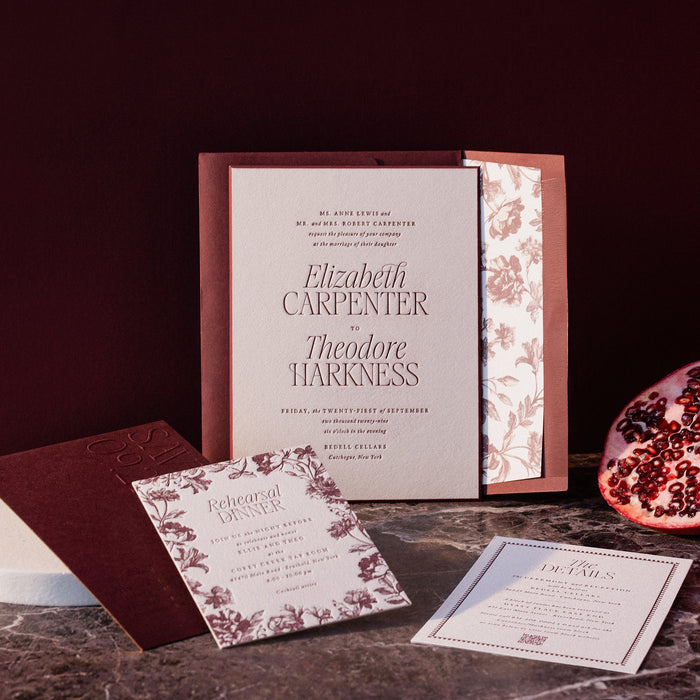 Harkness wedding invitation set with floral design on a dark surface