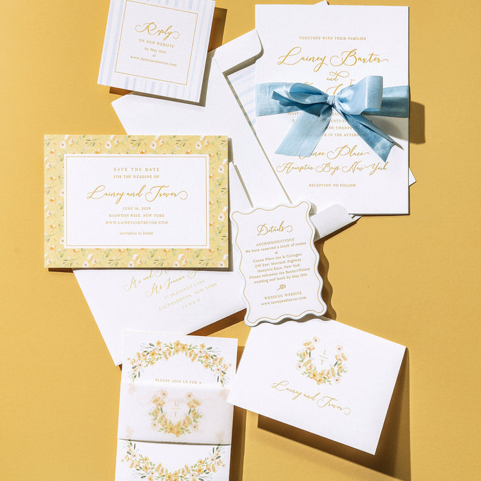 Lainey wedding invitation set with blue ribbon on a yellow background