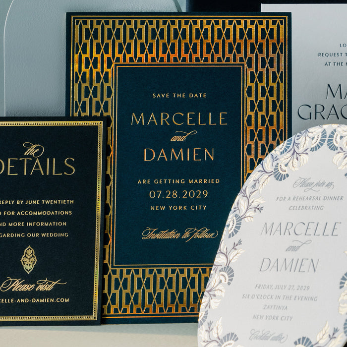 Wedding invitation cards with gold and blue design on a light gray background