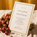 Italo wedding invitation card with grapes on a textured surface.