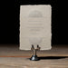Vintage-style wedding invitation reception card on a stand against a dark background