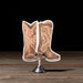 Decorative cowboy boot after party card on a stand against a dark background