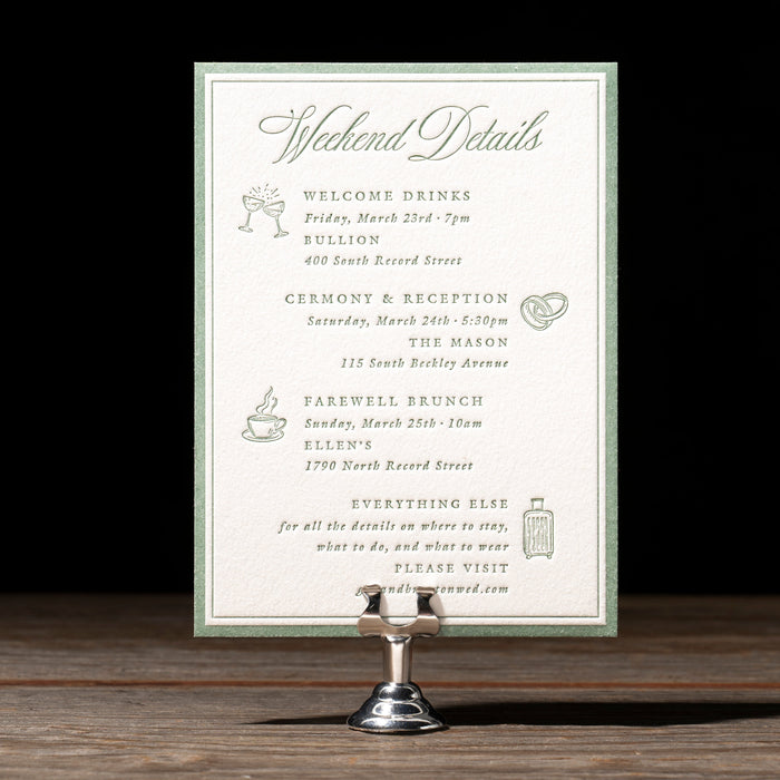 Braxton wedding details card on a stand with a dark background