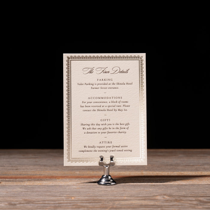 Canfield details card on stand against dark background