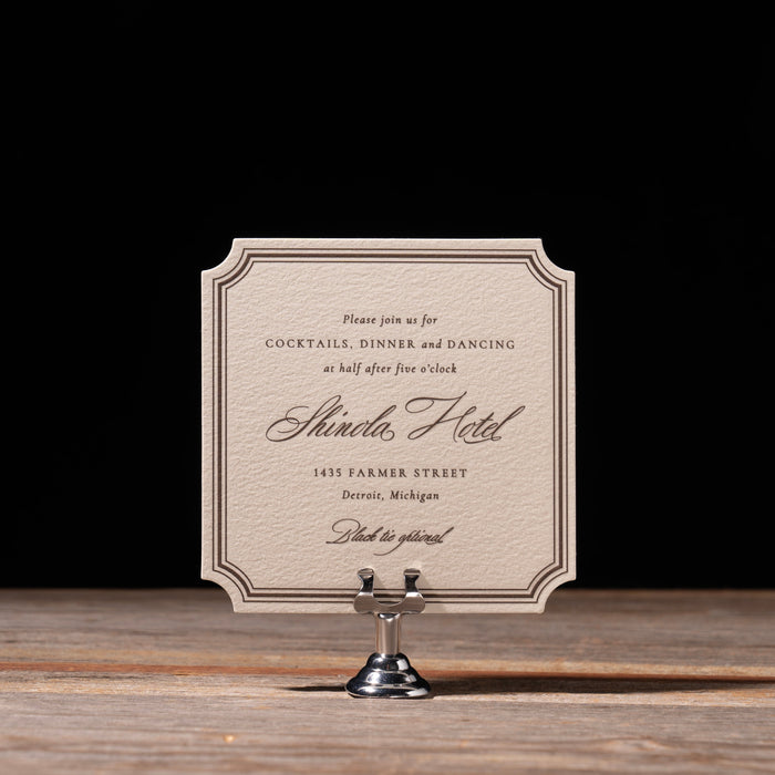 Canfield reception card on stand against dark background