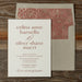 Celina wedding invitation card with floral design on the envelope against a wooden background