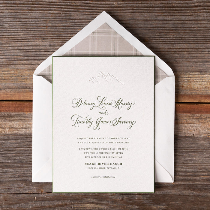Cheyenne wedding invitation card with plaid lining on a wooden surface