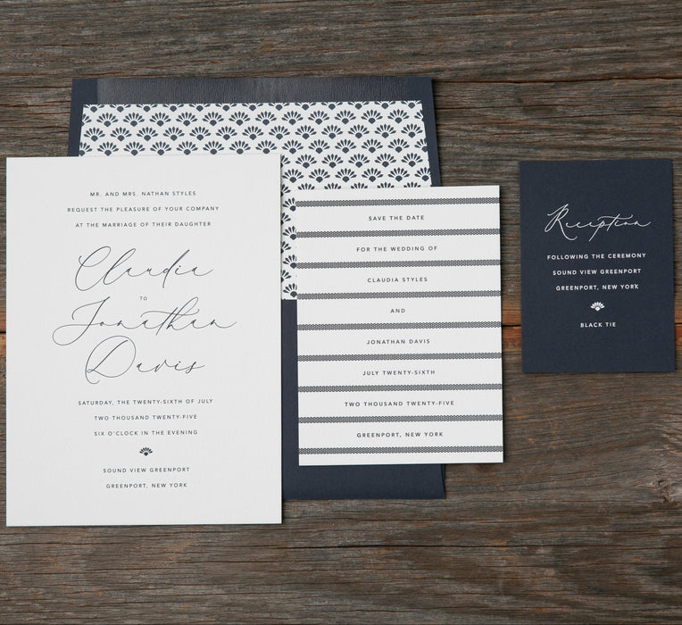 Wedding invitation set with RSVP card on a wooden surface