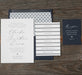 Wedding invitation set with RSVP card on a wooden surface