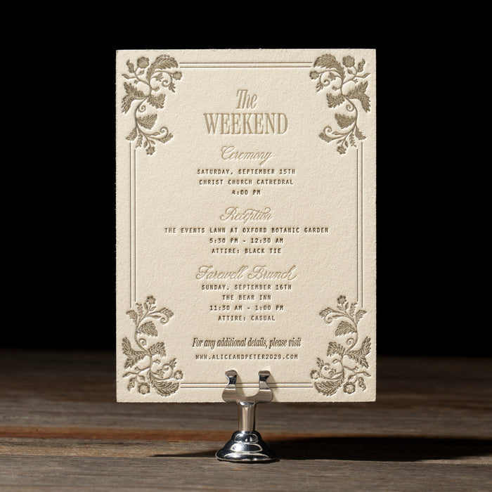 Decorative weekend card from Darcy Suite on a stand against a dark background.