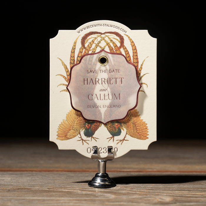 Decorative Devonshire 'Save the Date' card with floral design on a wooden surface