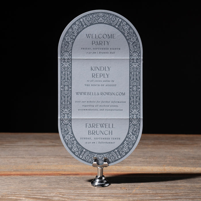 Decorative invitation insert card on a stand with a black background