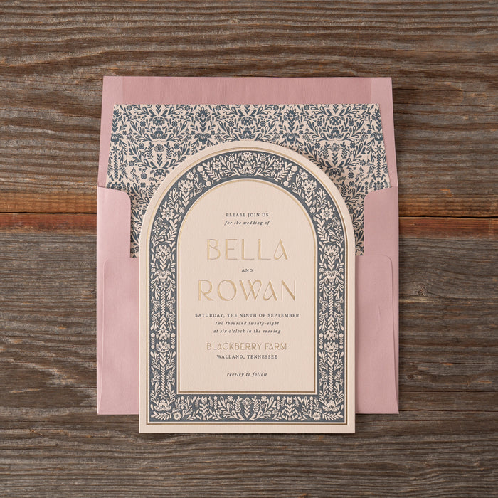 Invitation card with decorative border on a wooden surface