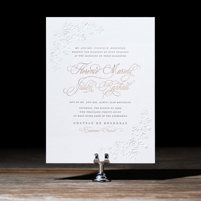 Elegant wedding invitation on a stand with a black background