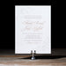 Elegant wedding invitation on a stand with a black background