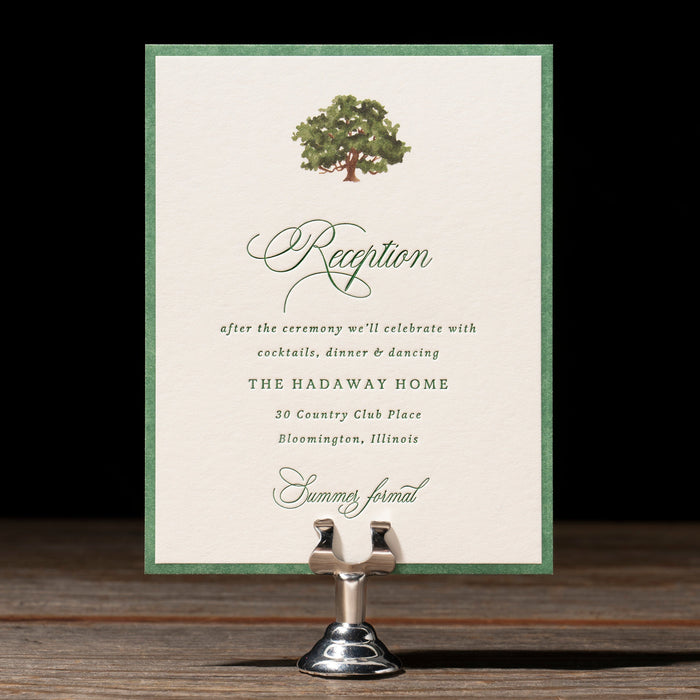 Wedding reception card on a stand with a dark background