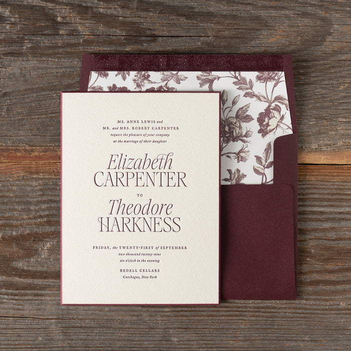 Harkness wedding invitation set with floral design on a wooden surface