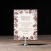 Harkness rehearsal dinner invitation with floral design on a wooden surface