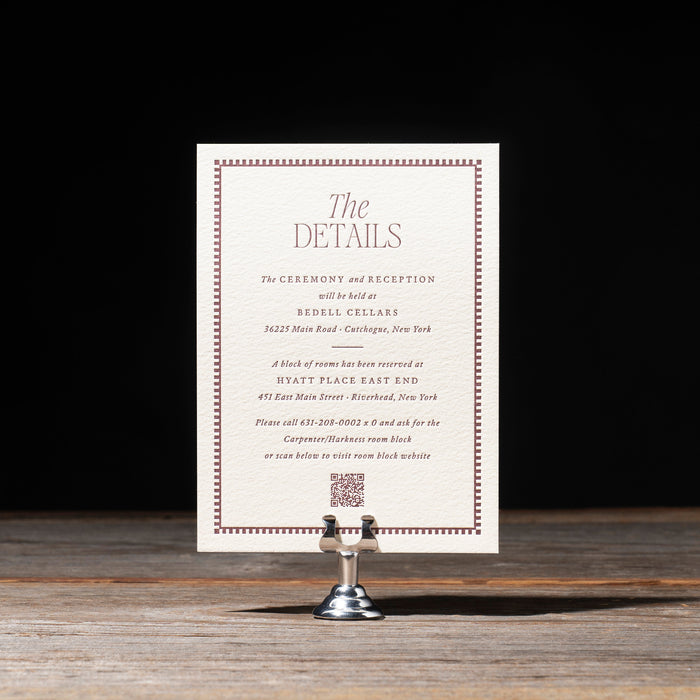 Wedding details card on a stand with a dark background