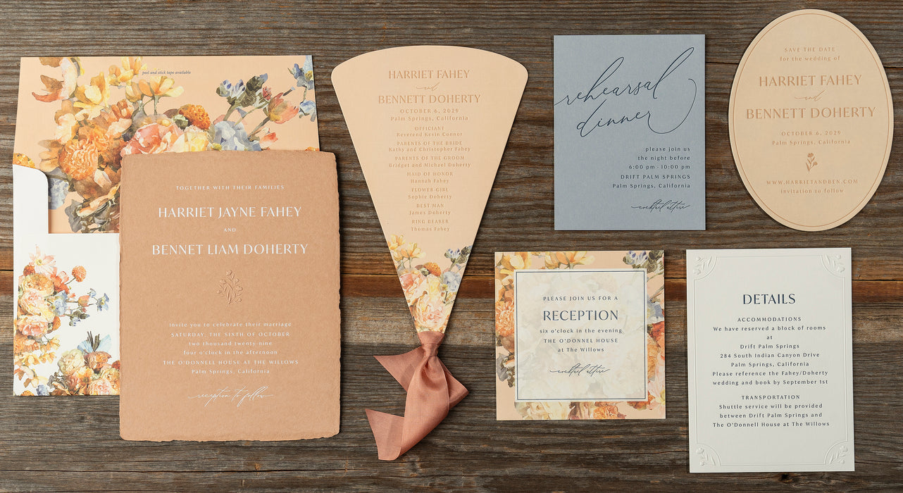Harriet Wedding invitation suite with floral designs on a wooden surface