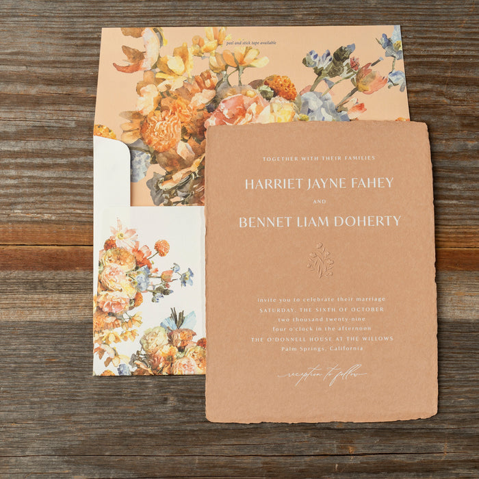 Harriet Wedding invitation with floral design on a wooden surface