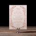 Wedding menu with floral design on a stand against a dark background